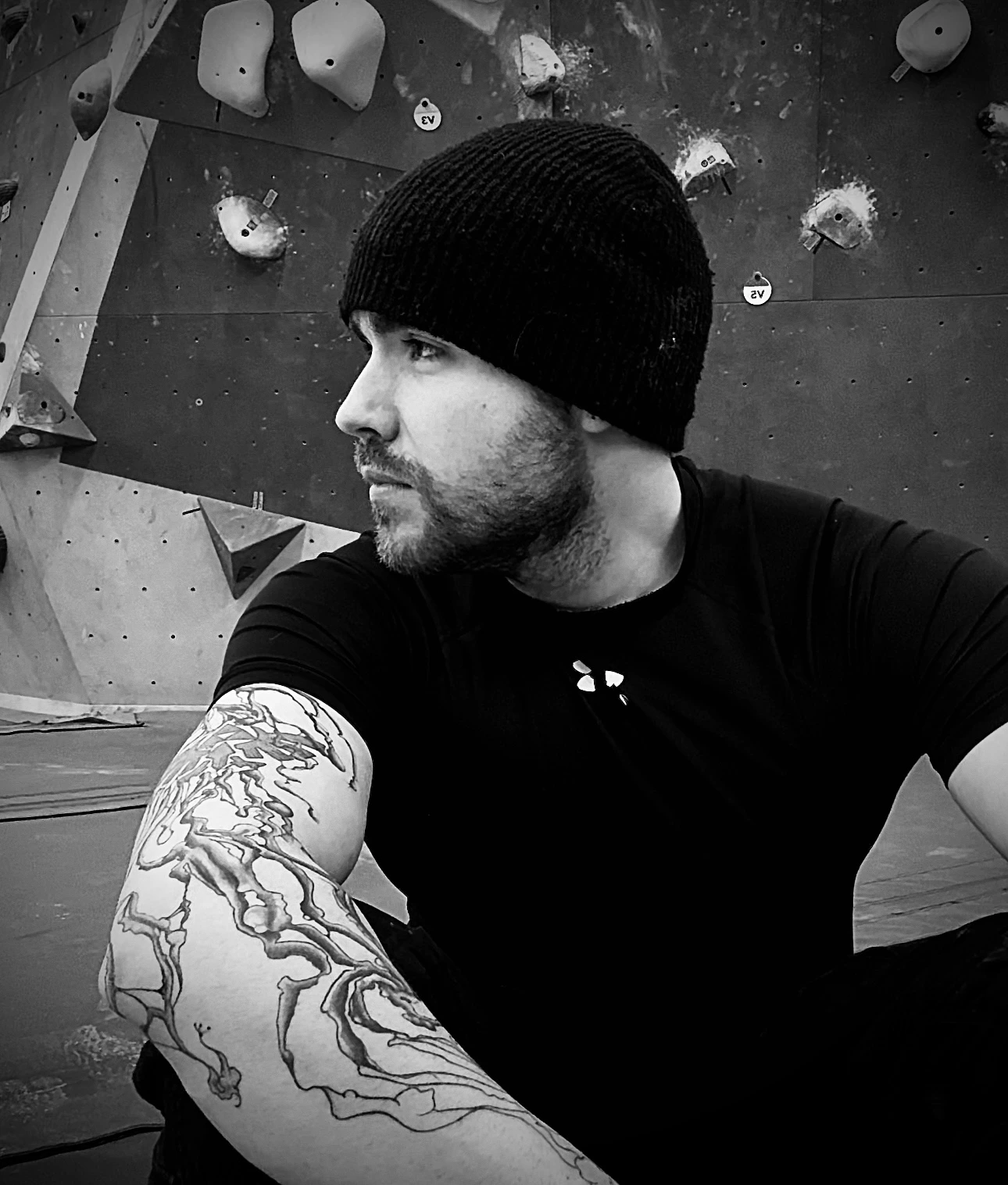 Zach, founder of BoulderBase, at the bouldering wall